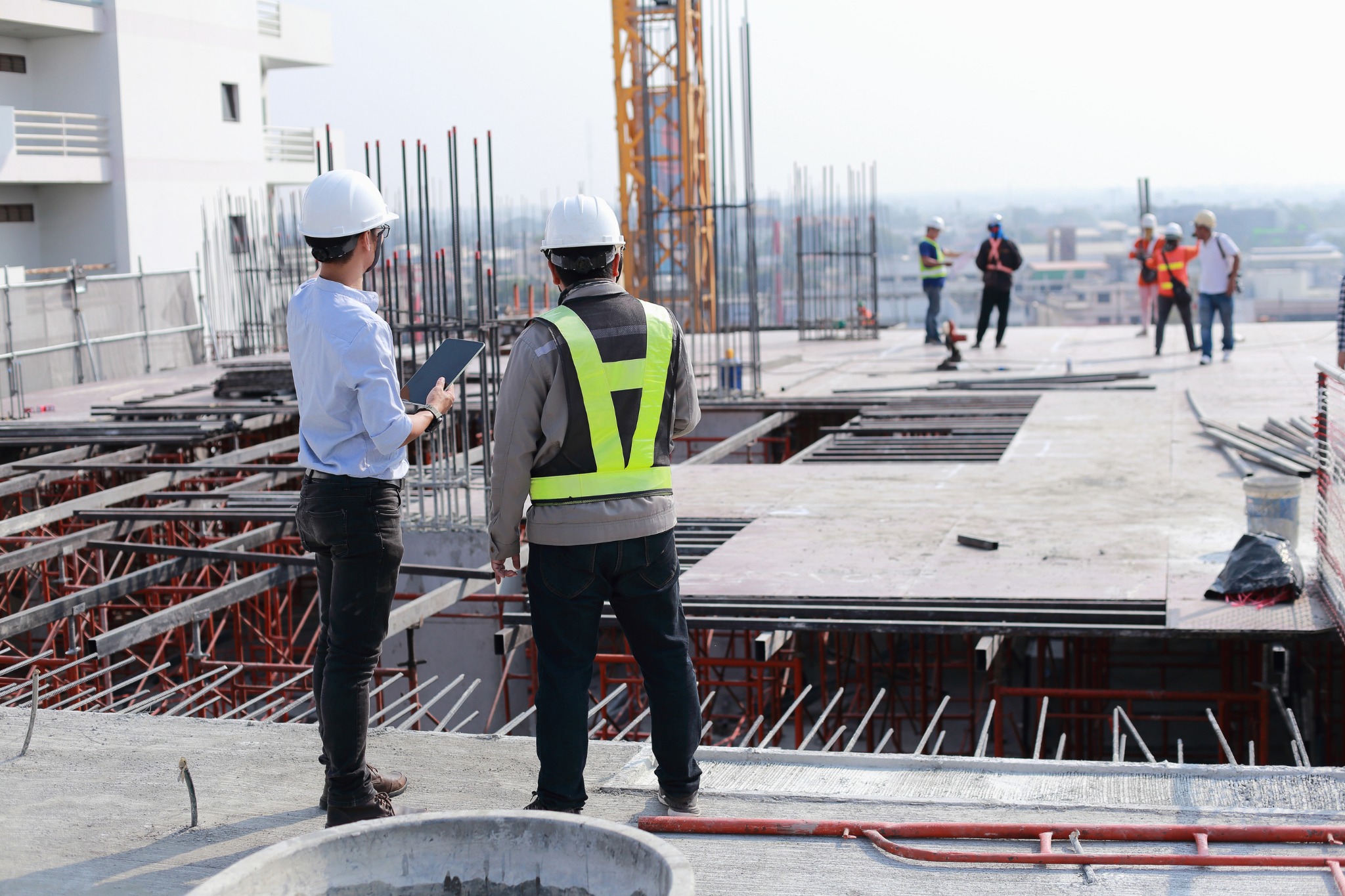 Elegant Nivasa engineering team inspecting slab work